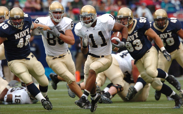 Football athletes running on field