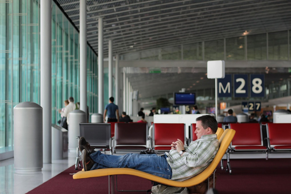 Man waiting for his flight comfortable in compression socks for air travel