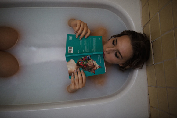 A woman taking a bath with Epsom salts for sore muscles